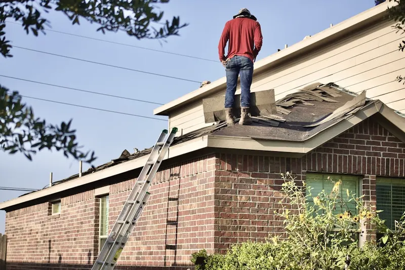 Professional roofer working on a residential roof in South Perris